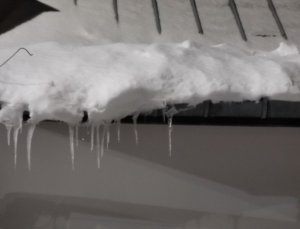 Śnieg i lód spadający z dachu